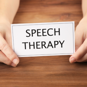 hands holding a card that says the words "speech therapy" 